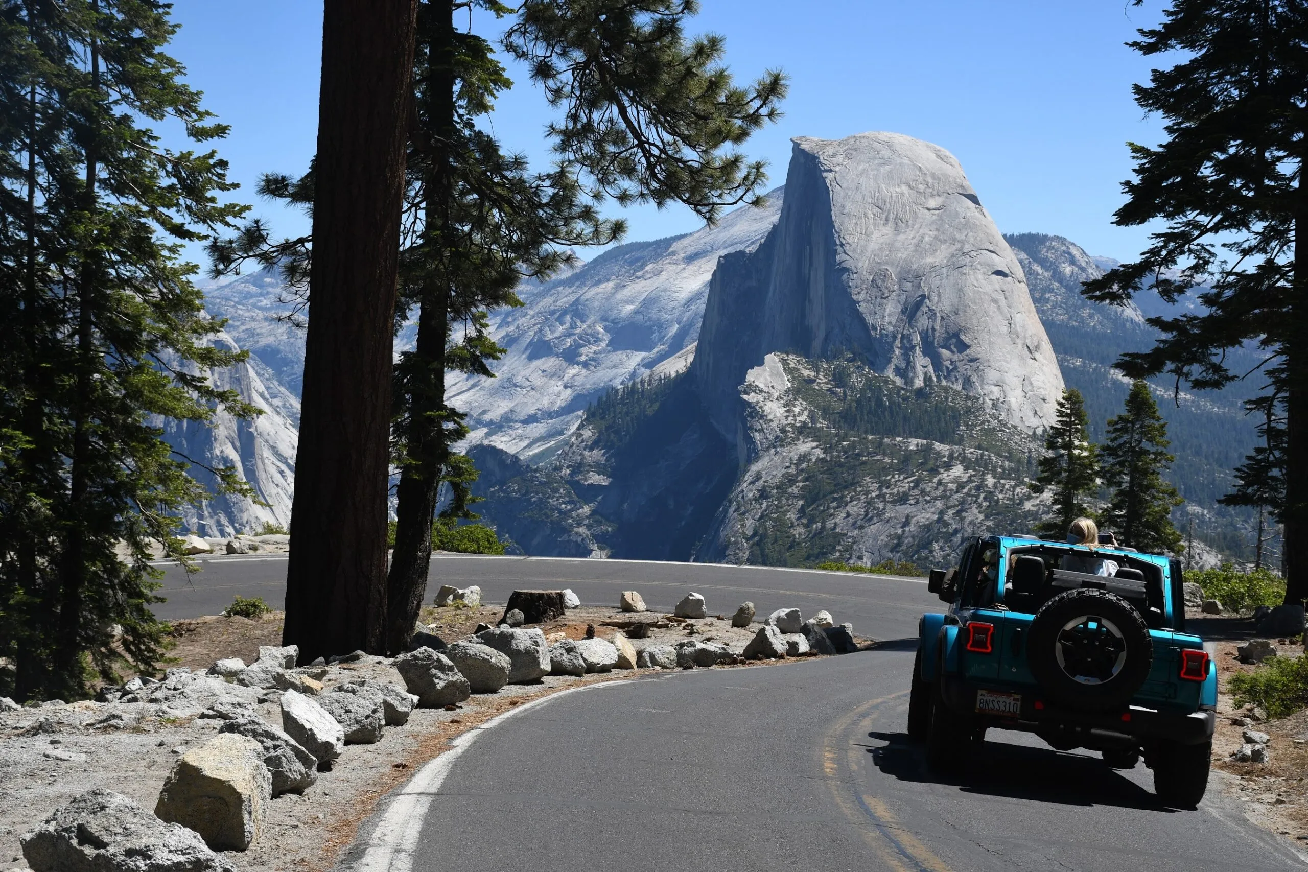 A Crossroads Tours jeep at a Glacier Point overlook with Yosemite Valley behind